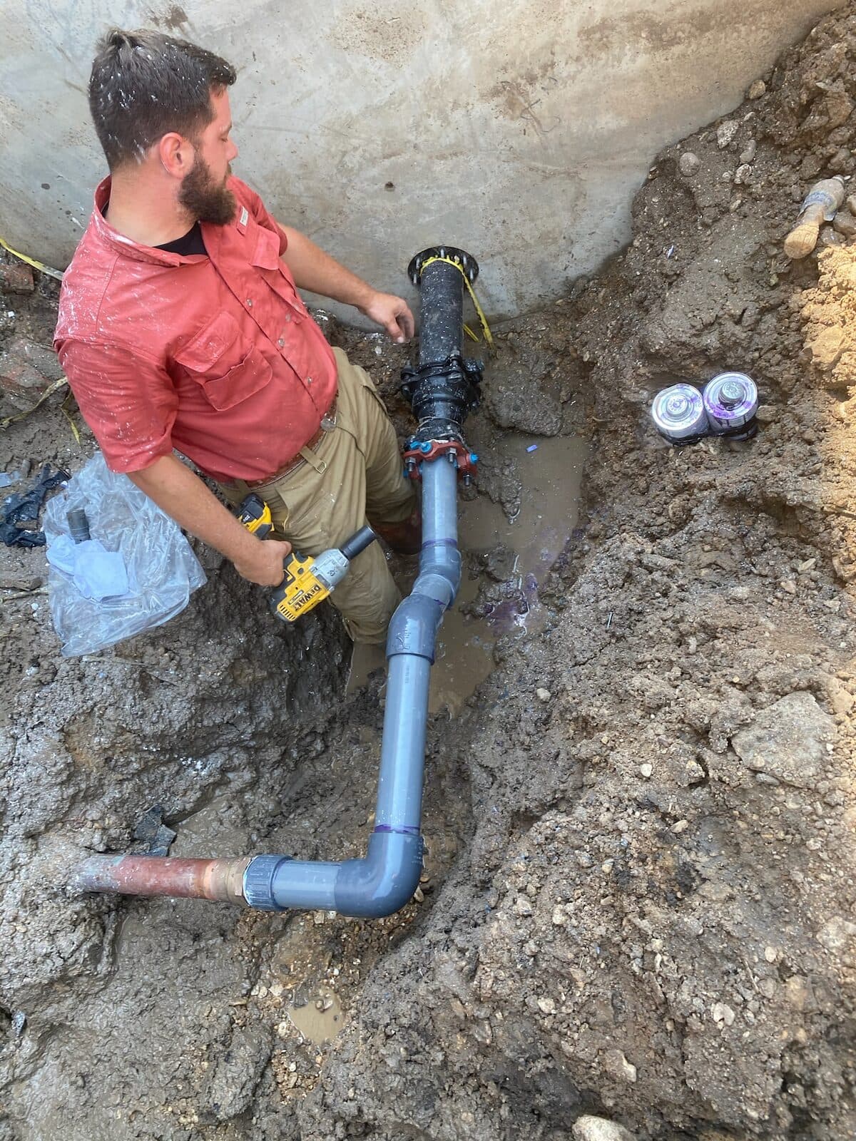 Streamline technician servicing a drain and waste line