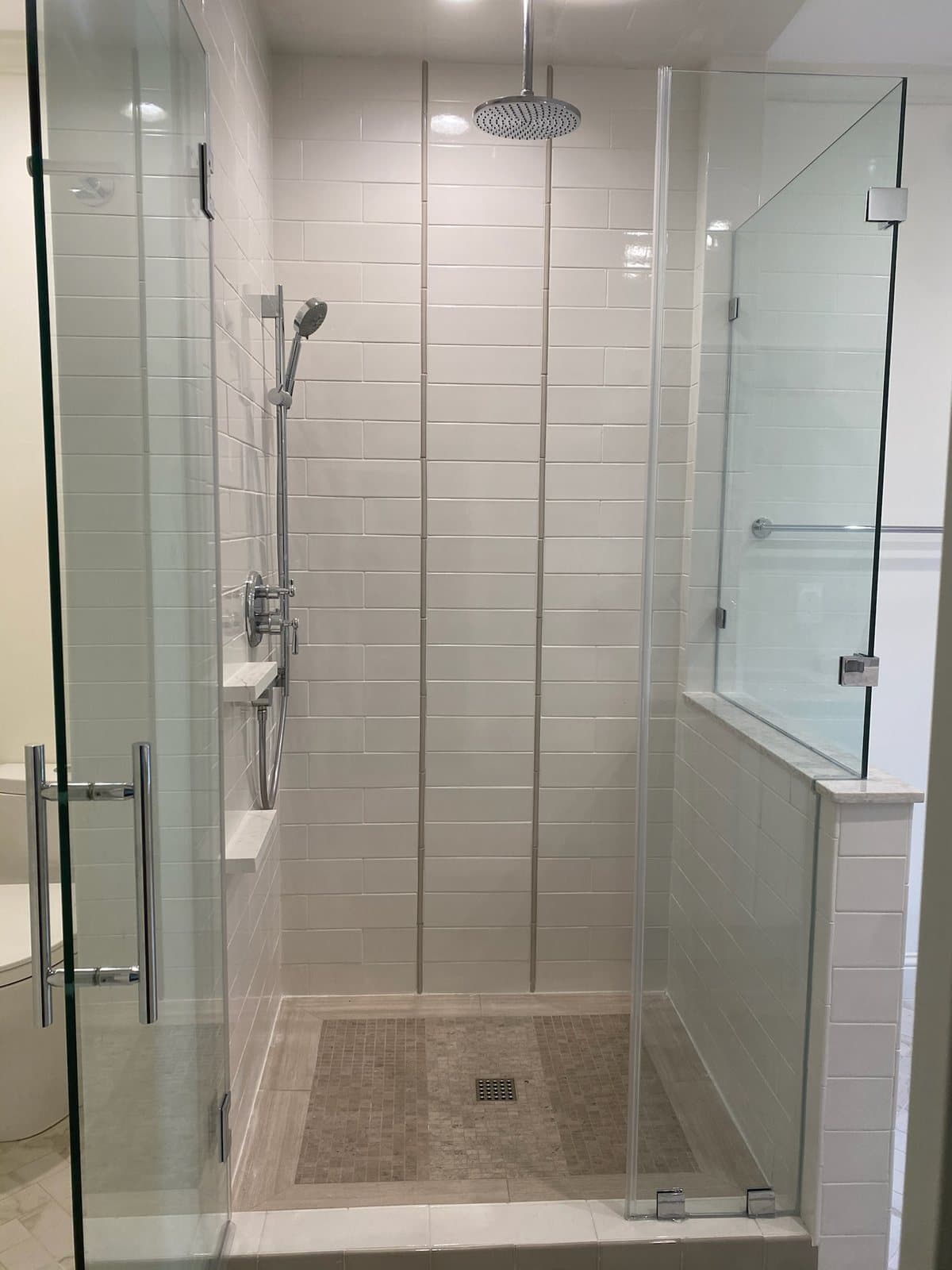 Finished tiled shower with glass enclosure