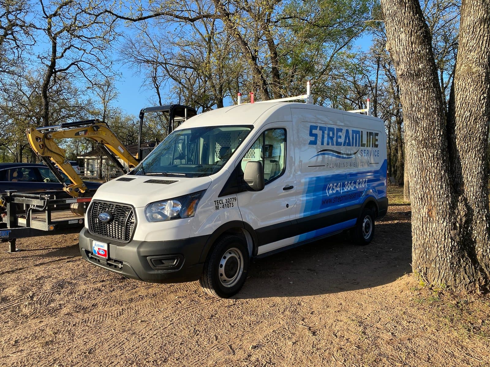 Streamline Service van parked near excavation equipment