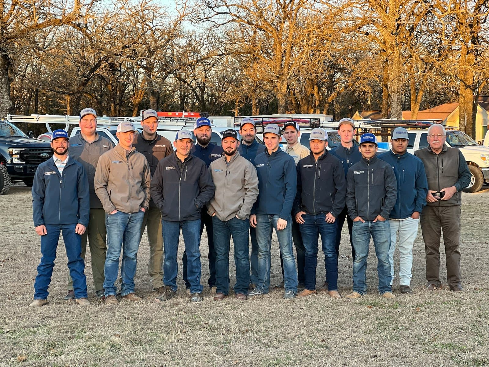 Streamline Service team standing in front of the company fleet